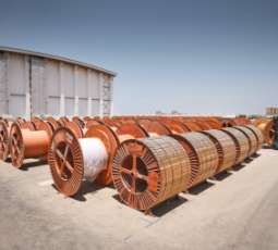 spools of cable outside a large building